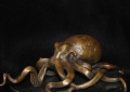 EL PULPO, 5 x 4 x 3 inches. One-of-a-kind, bronze octopus, mounted on a black granite base. Created directly in wax. All casting, metal work and patina done by Ed.