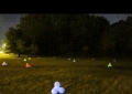 LIFE, elements separated. Colored oversized balloons lit with glow sticks are scattered in a field, representing the four basic molecules of life.
